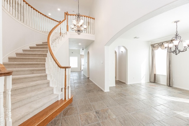 5923 Union Spgs, Sugar Land, TX 77479 - entryway with a chandelier, arched walkways, baseboards, stairway, and a towering ceiling