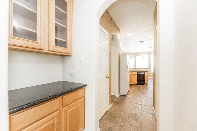 5923 Union Spgs, Sugar Land, TX 77479 - bar area with arched walkways, freestanding refrigerator, stone tile flooring, baseboards, and dishwasher