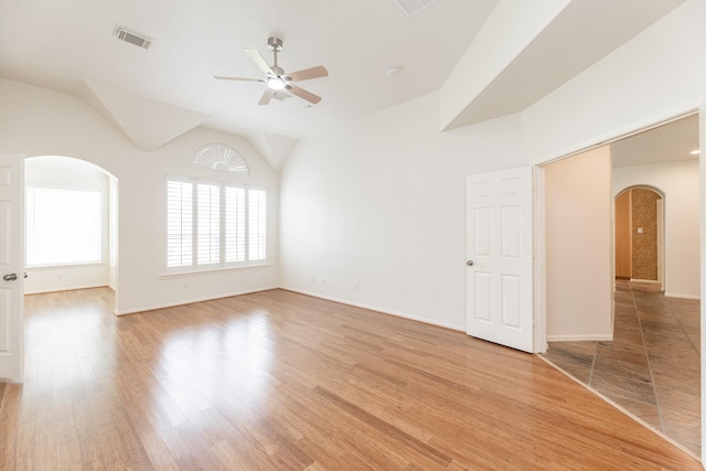 5923 Union Spgs, Sugar Land, TX 77479 - spare room featuring arched walkways, ceiling fan, light wood-style flooring, baseboards, and lofted ceiling
