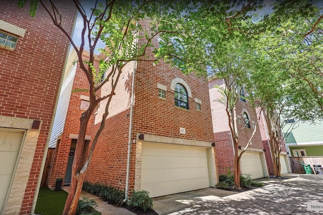 2505 Brinkman St, Houston, TX 77008 - view of home's exterior featuring brick siding, an attached garage, and concrete driveway