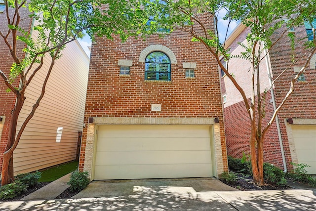 2505 Brinkman St, Houston, TX 77008 - view of front facade featuring brick siding, a garage, and driveway
