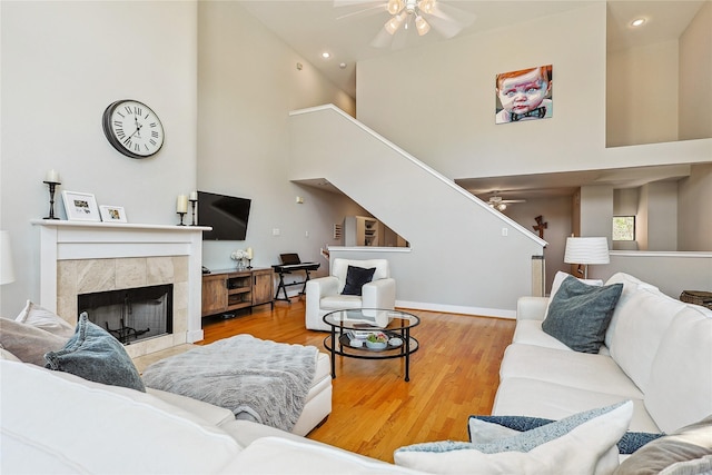 2505 Brinkman St, Houston, TX 77008 - living room featuring ceiling fan, high vaulted ceiling, a tiled fireplace, wood finished floors, and recessed lighting