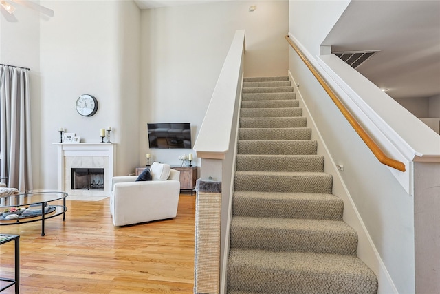 2505 Brinkman St, Houston, TX 77008 - staircase with wood finished floors, a fireplace, and a high ceiling