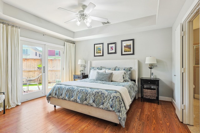 2505 Brinkman St, Houston, TX 77008 - bedroom featuring access to outside, wood finished floors, a tray ceiling, and ceiling fan