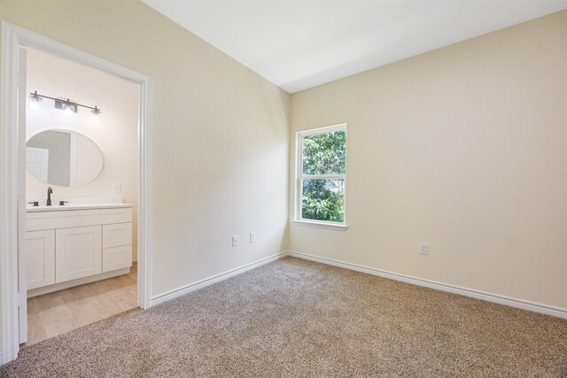 16960 W Dounreay, Montgomery, TX 77316 - unfurnished bedroom with light colored carpet and ensuite bath