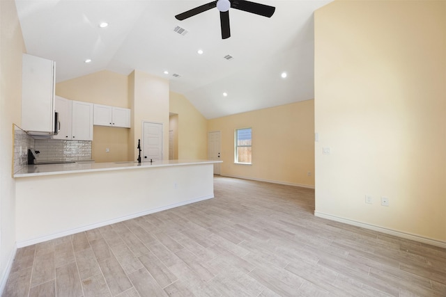 16960 W Dounreay, Montgomery, TX 77316 - kitchen featuring a ceiling fan, a peninsula, open floor plan, light wood finished floors, and light countertops