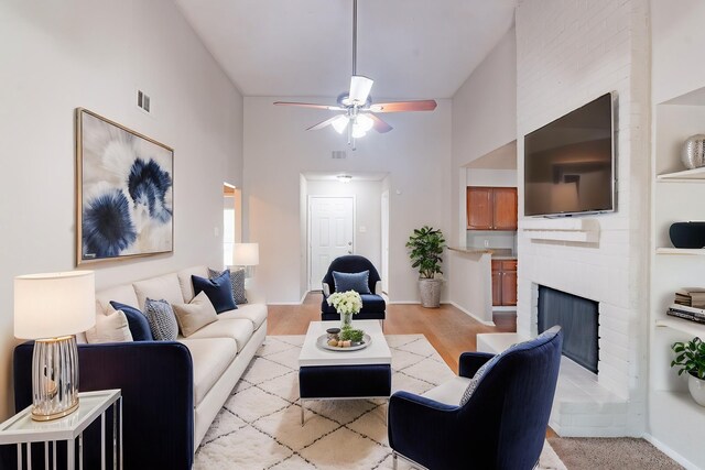 2302 Peaceful Valley Dr, Spring, TX 77373 - living room with ceiling fan, light wood-style floors, a brick fireplace, and a high ceiling