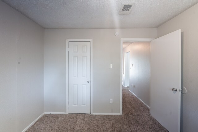 2302 Peaceful Valley Dr, Spring, TX 77373 - unfurnished bedroom featuring carpet, a textured ceiling, and baseboards
