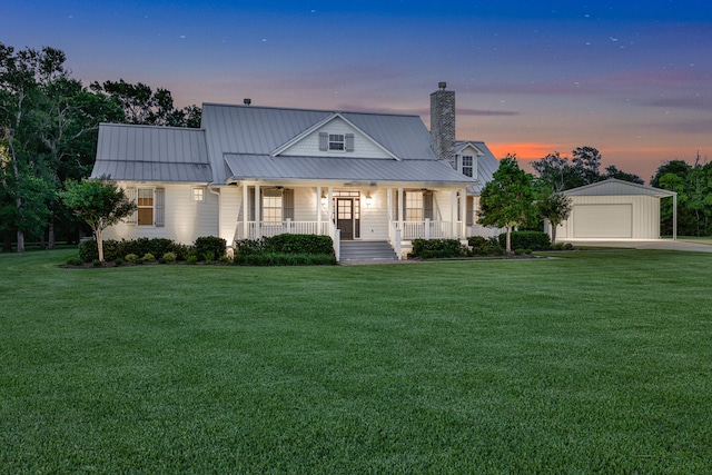 5926 Bit Pl, Baytown, TX 77523 - view of front of property featuring covered porch, a chimney, a lawn, an outbuilding, and a garage