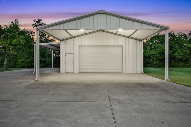 5926 Bit Pl, Baytown, TX 77523 - garage at dusk featuring a detached garage, a lawn, and concrete driveway