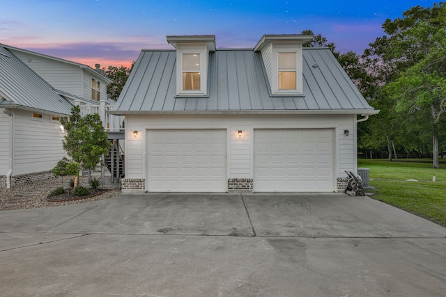 5926 Bit Pl, Baytown, TX 77523 - garage at dusk with a garage and a lawn