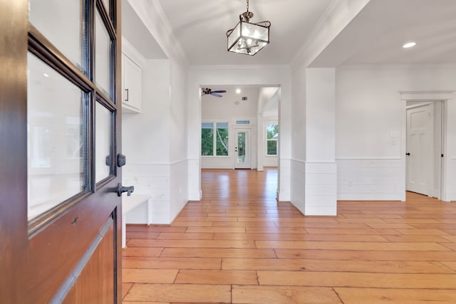 5926 Bit Pl, Baytown, TX 77523 - entryway featuring light wood-type flooring, ornamental molding, ceiling fan, a wainscoted wall, and a chandelier