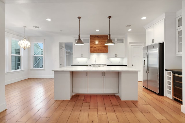 5926 Bit Pl, Baytown, TX 77523 - kitchen with stainless steel fridge with ice dispenser, beverage cooler, decorative backsplash, white cabinetry, and a sink