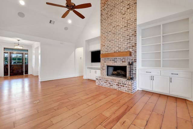 5926 Bit Pl, Baytown, TX 77523 - unfurnished living room featuring a ceiling fan, high vaulted ceiling, a fireplace, light wood finished floors, and built in shelves