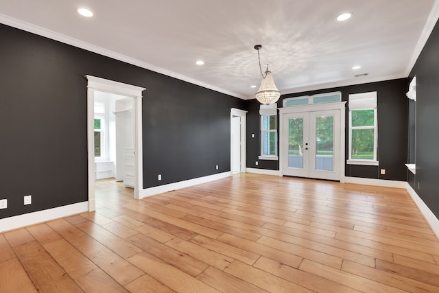 5926 Bit Pl, Baytown, TX 77523 - empty room with a chandelier, crown molding, baseboards, recessed lighting, and light wood-style floors