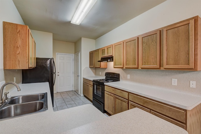 6106 Yorkglen Manor Ln, Houston, TX 77084 - kitchen with black appliances, under cabinet range hood, light countertops, and light tile patterned flooring