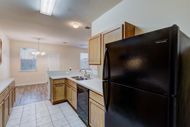 6106 Yorkglen Manor Ln, Houston, TX 77084 - kitchen featuring black appliances, a chandelier, light countertops, and plenty of natural light