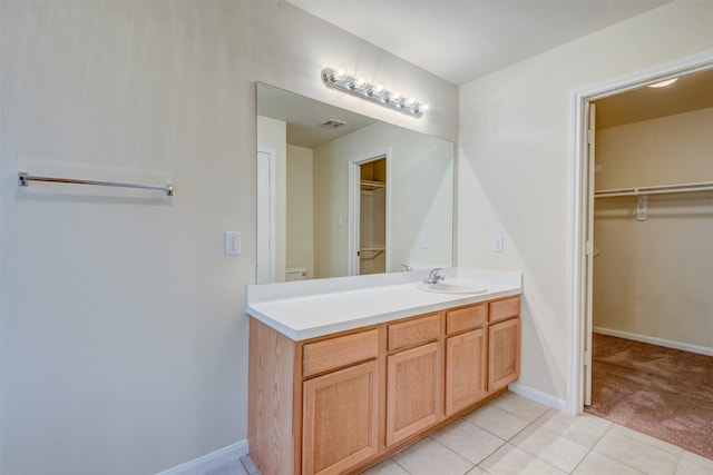 6106 Yorkglen Manor Ln, Houston, TX 77084 - bathroom with vanity, a walk in closet, and tile patterned floors