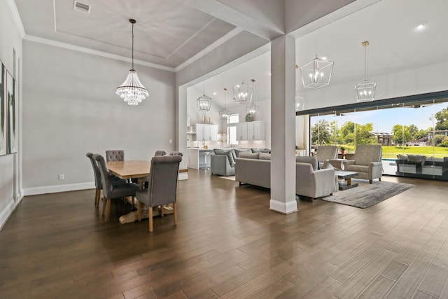 5318 Abington Creek Ln, Sugar Land, TX 77479 - dining space with a chandelier, dark wood-type flooring, crown molding, and baseboards