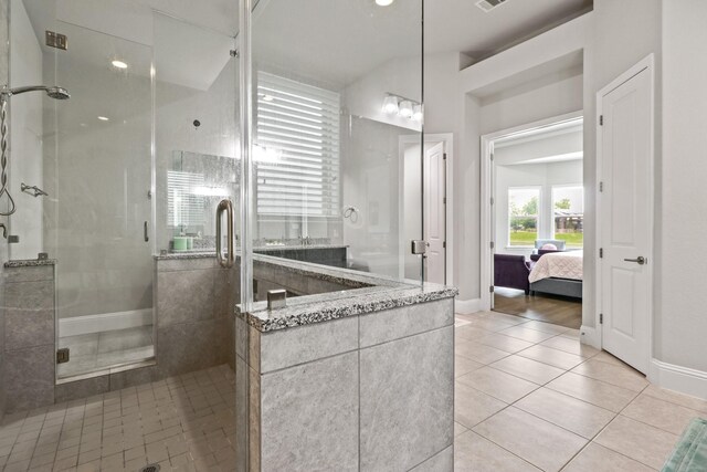 5318 Abington Creek Ln, Sugar Land, TX 77479 - ensuite bathroom with tile patterned floors, a stall shower, and baseboards
