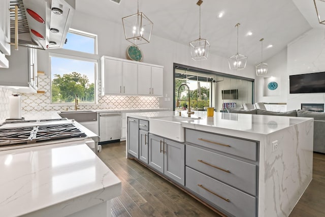 5318 Abington Creek Ln, Sugar Land, TX 77479 - kitchen with a sink, gray cabinetry, backsplash, dark wood-style floors, and a high ceiling