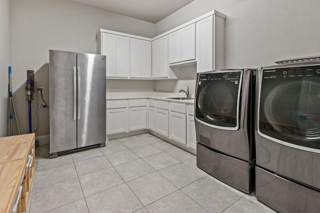 5318 Abington Creek Ln, Sugar Land, TX 77479 - washroom featuring washing machine and clothes dryer and light tile patterned floors