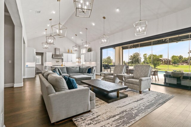 5318 Abington Creek Ln, Sugar Land, TX 77479 - living area with a chandelier, high vaulted ceiling, dark wood-style flooring, baseboards, and recessed lighting