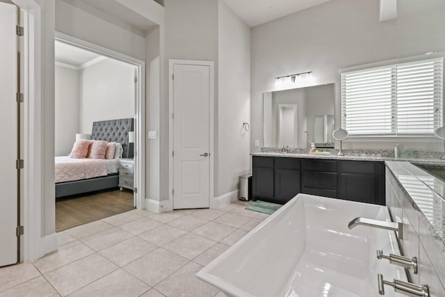 5318 Abington Creek Ln, Sugar Land, TX 77479 - bathroom featuring ensuite bathroom, tile patterned floors, vanity, a tub, and baseboards