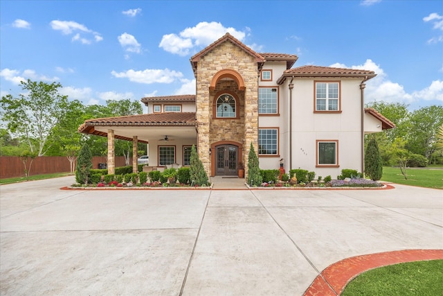 8917 Hawk Rd, Pearland, TX 77584 - mediterranean / spanish-style home with french doors, a ceiling fan, a tile roof, stucco siding, and stone siding