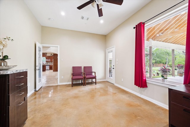 8917 Hawk Rd, Pearland, TX 77584 - living area with concrete floors, ceiling fan, baseboards, and arched walkways