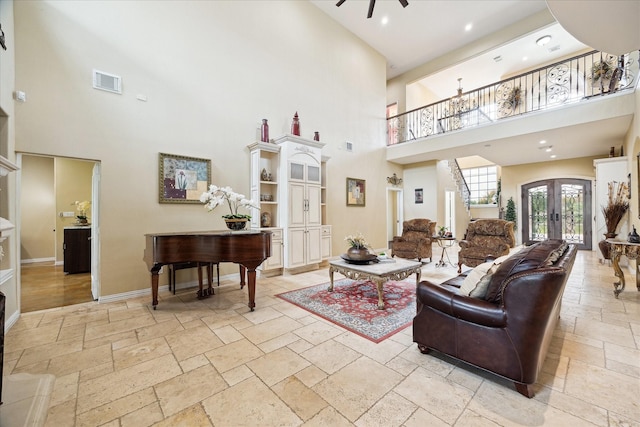 8917 Hawk Rd, Pearland, TX 77584 - living room featuring stone tile floors, a high ceiling, ceiling fan, baseboards, and recessed lighting