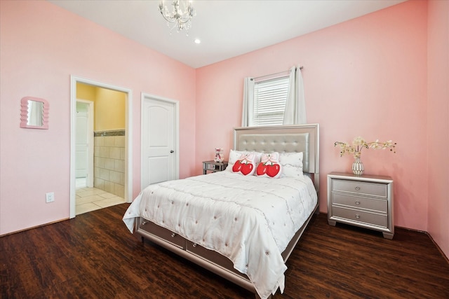 8917 Hawk Rd, Pearland, TX 77584 - bedroom with wood finished floors, a chandelier, tile walls, and ensuite bath