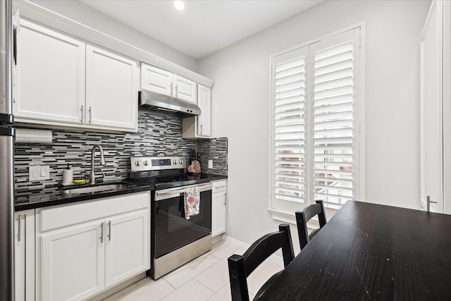 8917 Hawk Rd, Pearland, TX 77584 - kitchen with electric range, under cabinet range hood, a sink, backsplash, and light tile patterned flooring