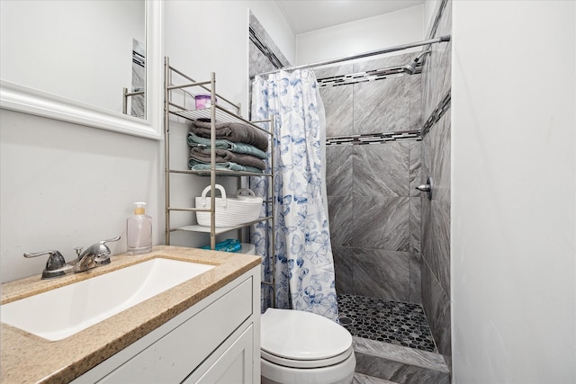 8917 Hawk Rd, Pearland, TX 77584 - bathroom with tiled shower, toilet, and vanity