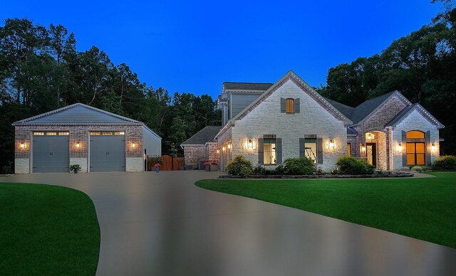 16572 Stonecrest Dr, Conroe, TX 77302 - view of front of home with brick siding, a front yard, stone siding, and a detached garage
