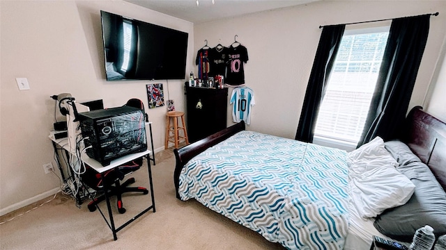 2911 Ribbon Creek Way, Spring, TX 77389 - carpeted bedroom featuring multiple windows and baseboards