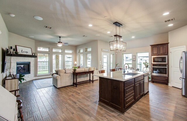 2335 Mayfield Trail Ct, League City, TX 77573 - kitchen featuring stainless steel appliances, a sink, plenty of natural light, dark brown cabinetry, and recessed lighting