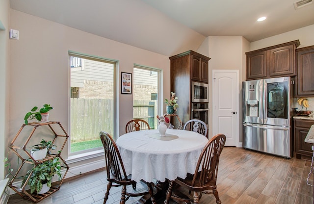 2335 Mayfield Trail Ct, League City, TX 77573 - dining area featuring healthy amount of natural light, light wood-type flooring, recessed lighting, lofted ceiling, and baseboards