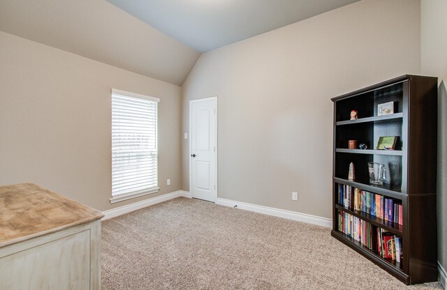 2335 Mayfield Trail Ct, League City, TX 77573 - carpeted spare room featuring lofted ceiling and baseboards