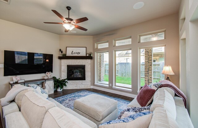 2335 Mayfield Trail Ct, League City, TX 77573 - living room with wood finished floors, a ceiling fan, a stone fireplace, and healthy amount of natural light