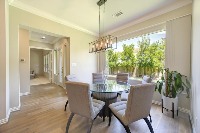 13706 Northwood Meadow Cir, Houston, TX 77077 - dining area featuring plenty of natural light, a chandelier, wood finished floors, and crown molding