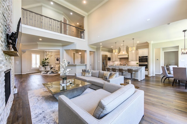 13706 Northwood Meadow Cir, Houston, TX 77077 - living area featuring dark wood finished floors, ornamental molding, a fireplace, baseboards, and a high ceiling