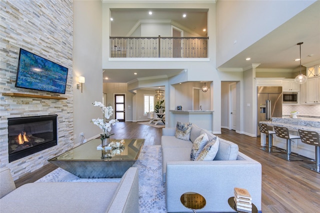 13706 Northwood Meadow Cir, Houston, TX 77077 - living area with a towering ceiling, dark wood-style flooring, baseboards, a fireplace, and ornamental molding