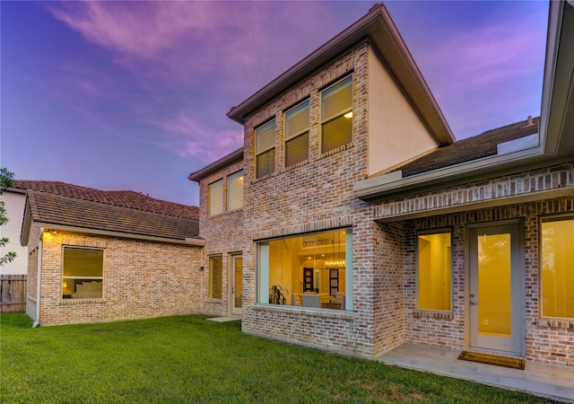 13706 Northwood Meadow Cir, Houston, TX 77077 - back of house at dusk with a yard and brick siding