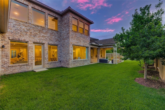 13706 Northwood Meadow Cir, Houston, TX 77077 - back of property at dusk featuring brick siding and central AC