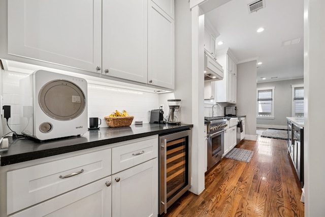 728 Allston St, Houston, TX 77007 - kitchen featuring wine cooler, high end range, dark wood-style flooring, decorative backsplash, and dark countertops