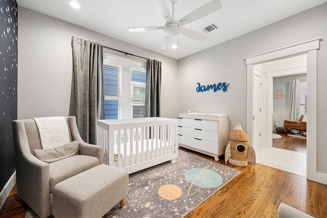 728 Allston St, Houston, TX 77007 - bedroom with wood finished floors, a crib, recessed lighting, and a ceiling fan