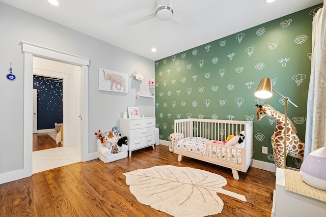 728 Allston St, Houston, TX 77007 - bedroom featuring a nursery area, wood finished floors, recessed lighting, baseboards, and a ceiling fan