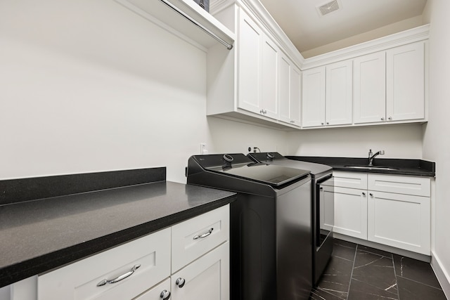728 Allston St, Houston, TX 77007 - laundry area featuring independent washer and dryer, cabinet space, and dark marble finish flooring
