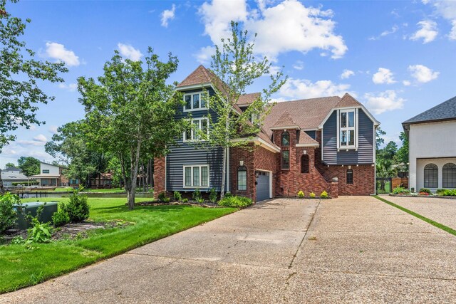 12986 Wood Harbour Dr, Montgomery, TX 77356 - view of front facade with concrete driveway, brick siding, and a front yard